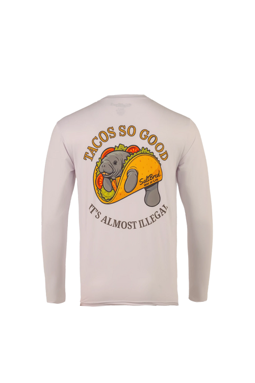 A light beige long-sleeve shirt shown from the back, featuring a graphic of a manatee inside a taco with the text 'TACOS SO GOOD' and 'IT'S ALMOST ILLEGAL'.