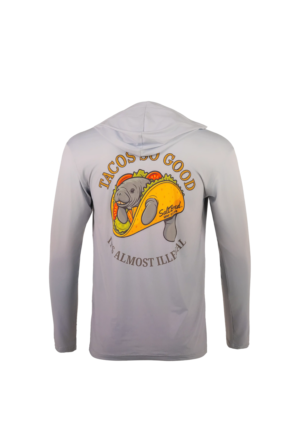 A light gray hooded long-sleeve shirt shown from the back, featuring a large graphic of a manatee inside a taco with the text 'TACOS GO GOOD' and 'I'M ALMOST ILLEGAL'.