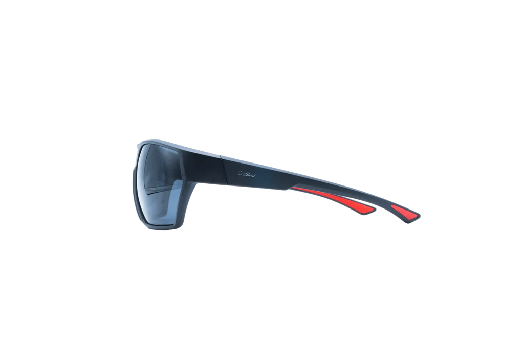 Side view of wrap-around sunglasses with a dark navy blue frame and red temple accents, set against a plain white background.