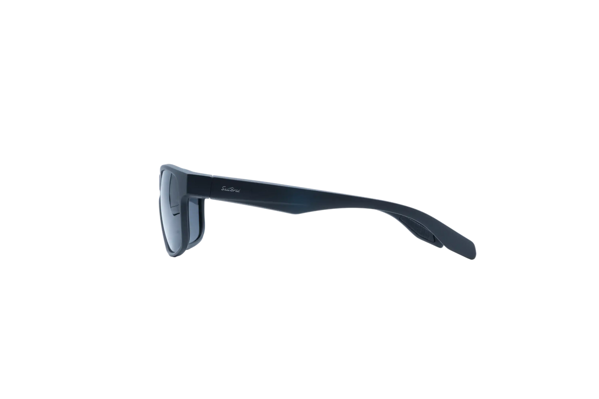 A pair of dark navy blue sunglasses shown from a side profile view against a solid white background.