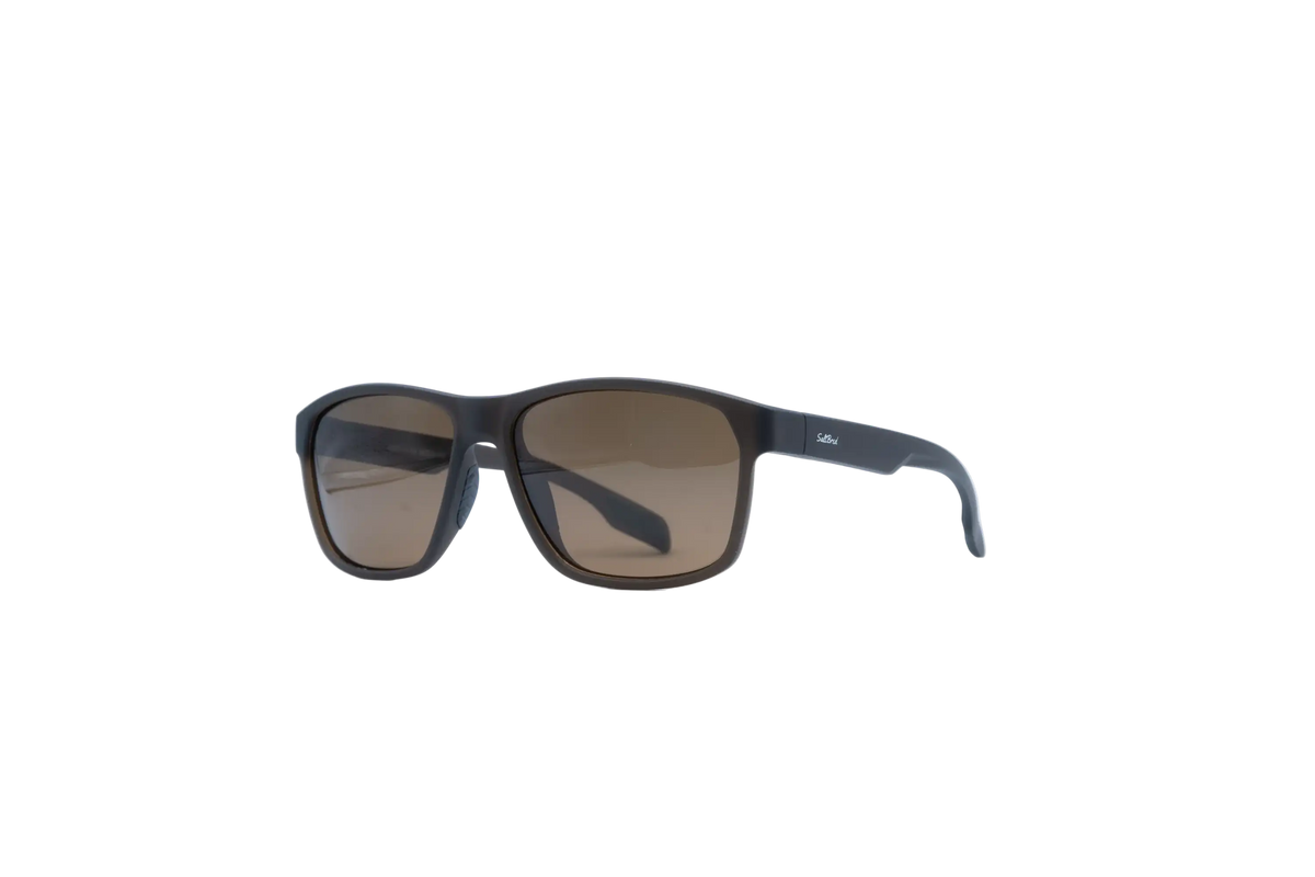 A pair of square sunglasses with a matte black frame and brown tinted lenses, shown from a three-quarters angle on a plain white background.